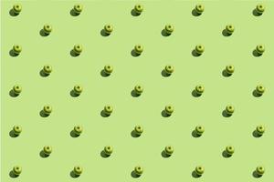 Minimal repetitive pattern made of green appes on green background photo