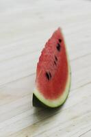 Close up of sliced watermelon fruit on wooden table backgrounds photo