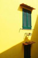 Green wooden window under brown awning photo