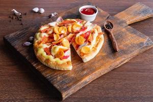 Flatbread pizza  on wooden pizza board photo