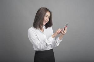 Business woman in white shirt on grey background photo