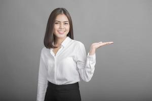 Business woman in white shirt on grey background photo