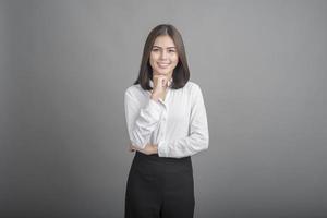 Business woman in white shirt on grey background photo