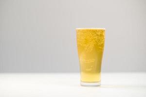 Beer in pint glass on white background photo