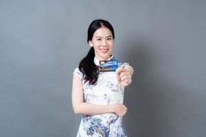 Asian woman wear Chinese traditional dress with hand holding credit card photo