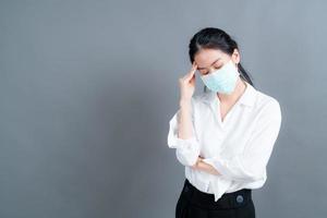 Mujer asiática con mascarilla médica protege el polvo del filtro pm2.5 anti-contaminación, anti-smog y covid-19 foto