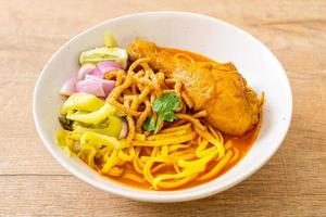 Northern Thai noodle curry soup with chicken photo