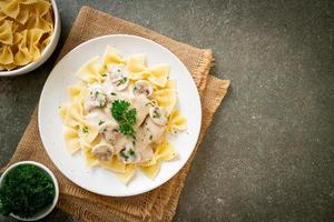 Farfalle pasta with mushroom white cream sauce - Italian food style photo