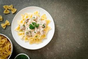 Pasta farfalle con salsa de crema blanca de champiñones - estilo de comida italiana foto