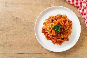 Farfalle pasta in tomato sauce with parsley - Italian food style photo