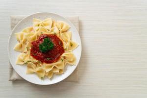 Farfalle pasta in tomato sauce with parsley - Italian food style photo