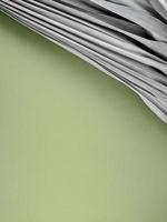 Dry beige palm leaf on fresh green background. Accommodation with space and composition for mockup, text, or design. Earth day, eco or natural theme, product display, nature concept. Vertical style. photo
