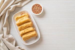 Fried tofu with sauce - vegan and vegetarian food style photo