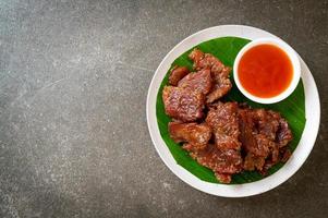 Sun-dried pork with sauce on a plate photo