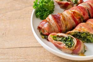 Baked bacon roll stuffed spinach and cheese photo