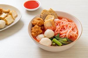 Small flat rice noodles with fish balls and shrimp balls in pink soup, Yen Ta Four or Yen Ta Fo - Asian food style photo