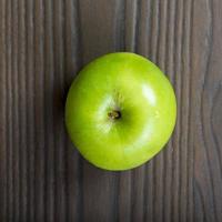 Apple on wood table photo