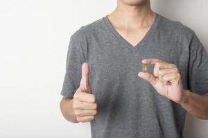 Man holding fish oil pill photo