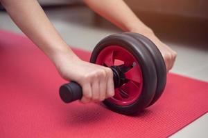 Using roller to do abdominal exercises from home photo