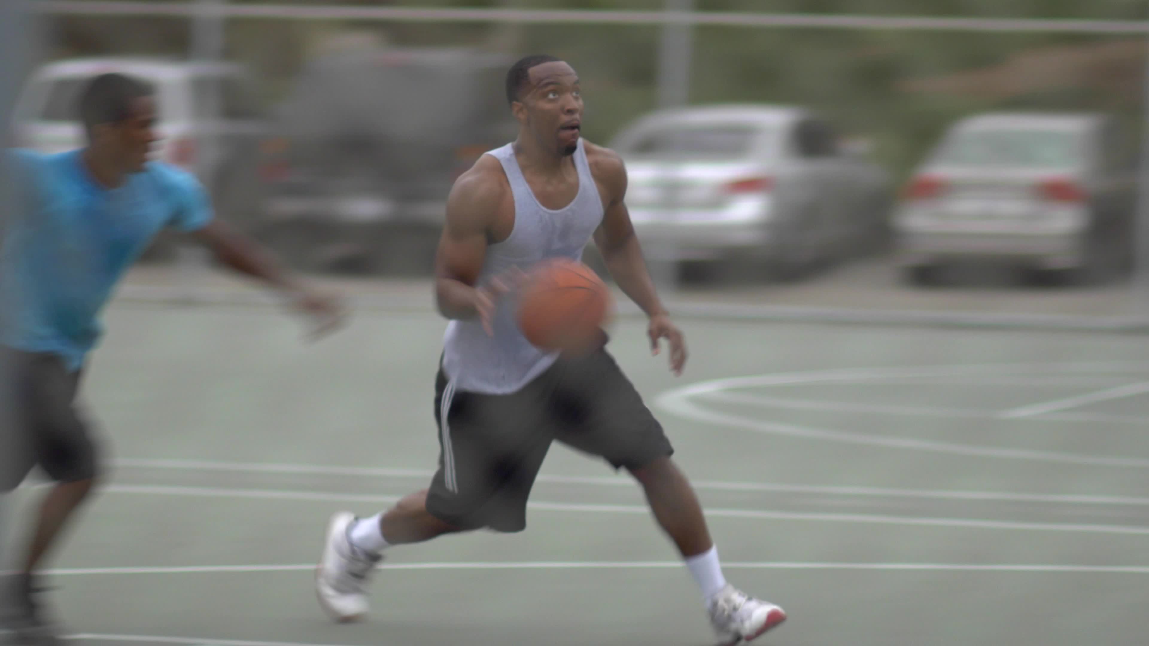 A young man basketball player missing a dunk while playing one on one
