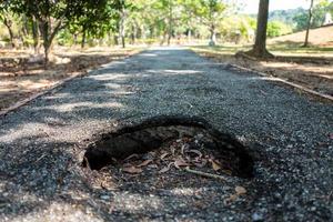 Hole in boardwalk of Langkawi Lagenda Park in Malaysia photo