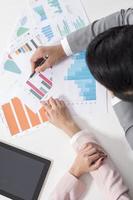 Businessman and businesswoman are analytic graph ,Business plan and business meeting concept photo