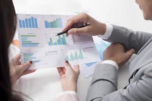 Businessman and businesswoman are analytic graph ,Business plan and business meeting concept photo