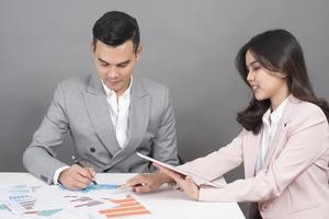 Businessman and businesswoman are analytic graph ,Business plan and business meeting concept photo