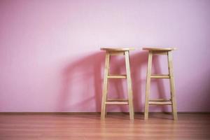 Bar stools on pink wall photo