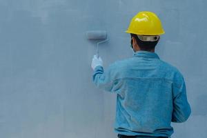 technician using paint roller photo