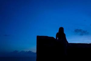 Silhouette of girl in the Uluwatu temple area in Bali photo