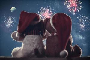 Two teddy bears enjoying Christmas and New Year Eve, New Year celebration concept. photo