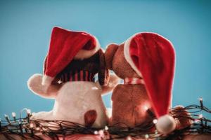Two teddy bears enjoying Christmas and New Year Eve, New Year celebration concept. photo