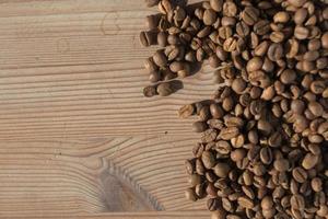 Coffe beans on the wooden background photo