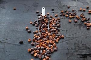 Coffee beans roasted on a black wooden background photo