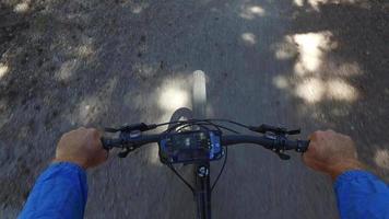 POV of a man riding his mountain bike on a singletrack dirt trail in the woods. video