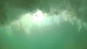 POV of waves breaking in the surf at the beach.