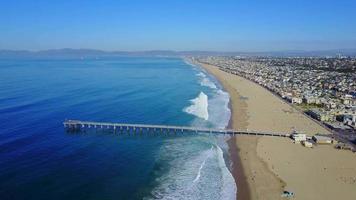 Aerial drone uav view of a pier over the beach and ocean. video