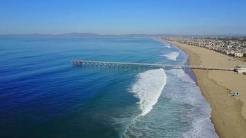 Aerial drone uav view of a pier over the beach and ocean. video