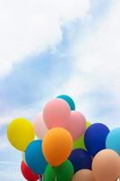 Bunch of colorful balloons against blue sky photo