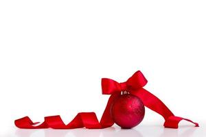 Red christmas ball, with red bow, isolated on white background, with copy space photo