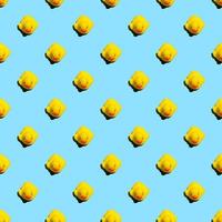 Small yellow rubber ducks on blue background seamless pattern summer background photo