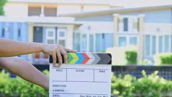 Manos de mujer sosteniendo tablero de colores de pizarra de película para la industria del cine y la televisión video