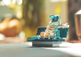 Warsaw, Poland, May 2019 - Lego mini-figure skeleton sitting on the bench photo