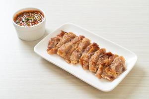 Grilled pork neck or charcoal-boiled pork neck with Thai spicy dipping sauce photo