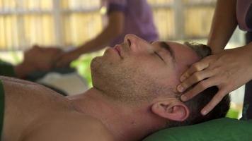 Detalle de un hombre recibiendo un masaje en un balneario.