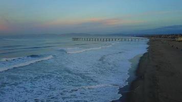 Aerial drone uav view of a pier, beach and ocean. video