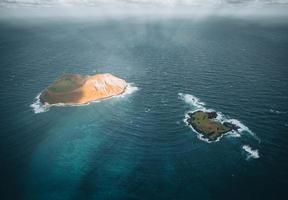 Helicopter aerial view of Mokulua Islands in Oahu, Hawaii photo