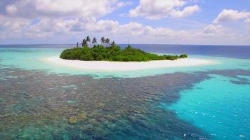 Aerial drone view of a coral reef and scenic tropical island in the Maldives. video