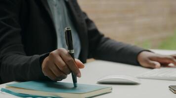 Close up of woman working with computer keyboard and pen photo